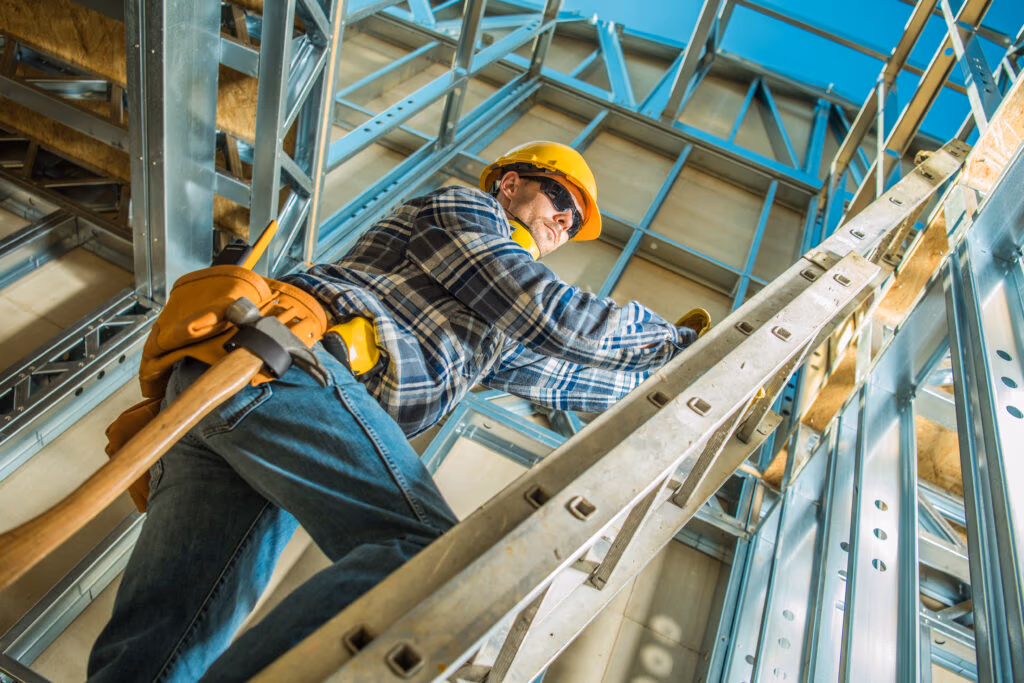 Construction worker stepping up an extension ladder