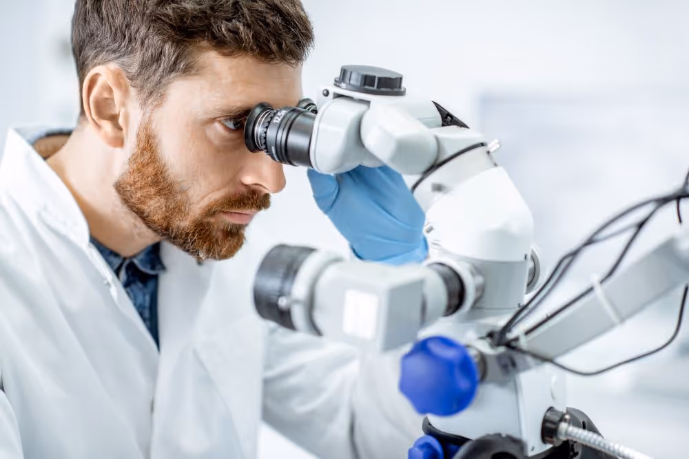 Scientist looking through microscope
