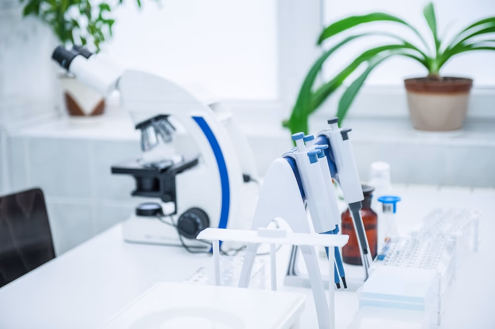 microscope and laboratory equipment on workbench
