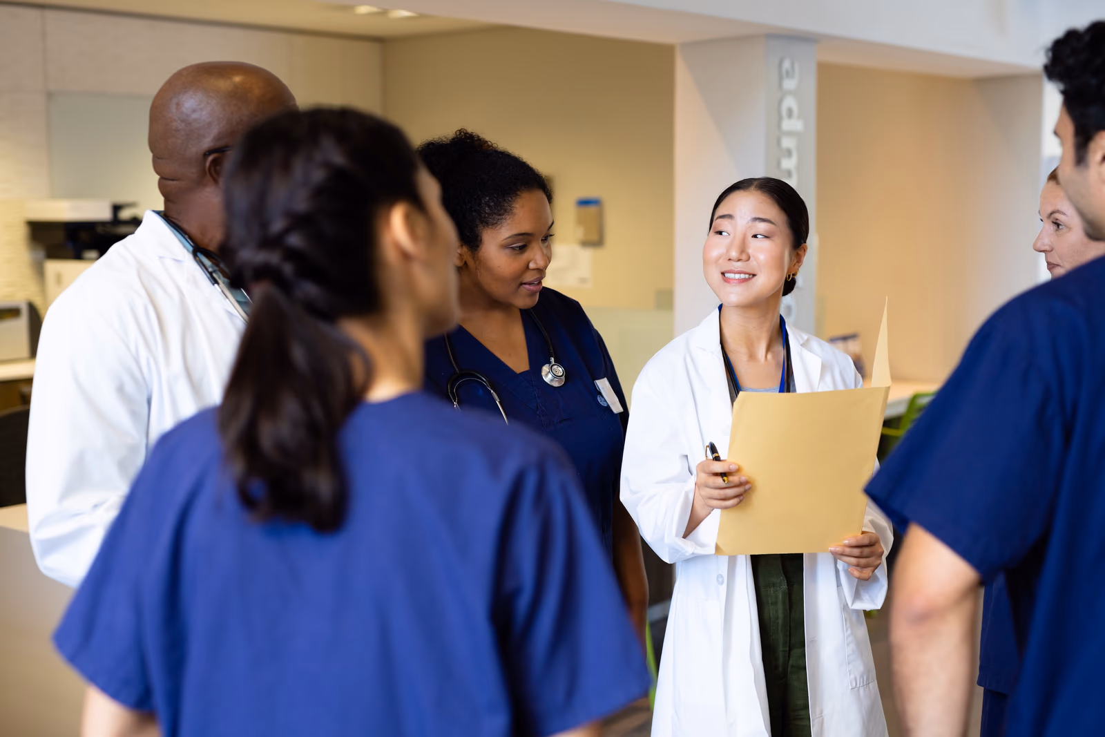 Doctor with folder talking with a colleague in a care setting