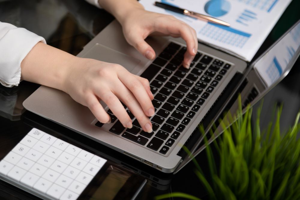 Woman using incident management software on a laptop