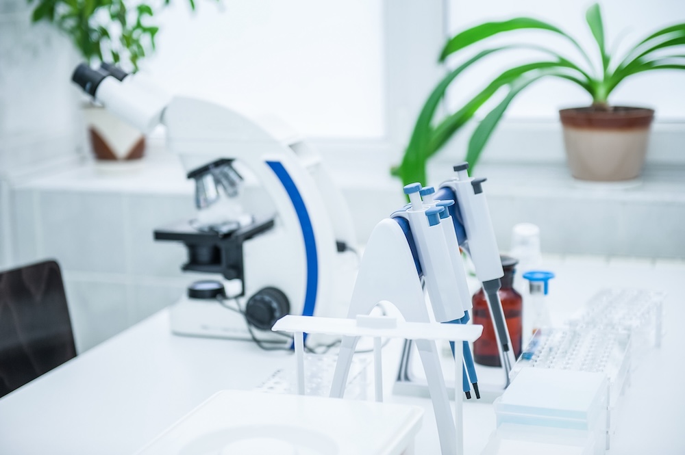 microscope and laboratory equipment on workbench