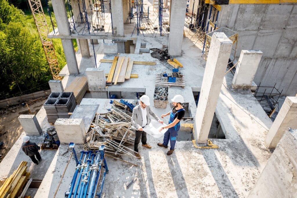 two workers reviewing building safety