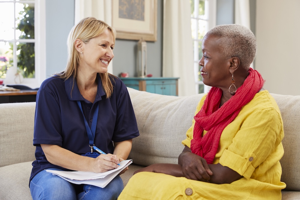 support worker conducting home visit risk assessment